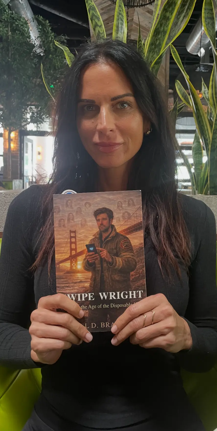 Ana Christian holding a copy of Swipe Wright by Joel D. Bradley.
